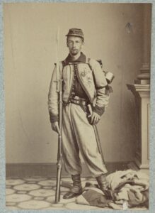 Francis E. Brownell, Pvt. 11th New York Infantry. First person to receive the Medal of Honor. This picture was taken soon after the killing. Pvt. Brownell can be seen standing on the Confederate flag that was flying above Jackson's Inn.